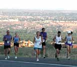 Runners making difficult climb